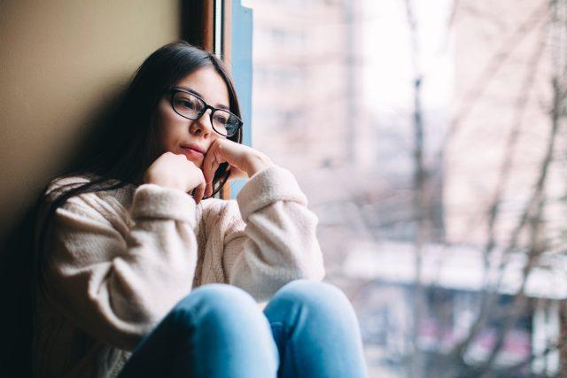 Sad,Teenage,Girl,Looking,Out,The,Window,On,A,Cold