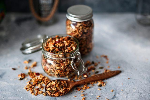 Home,Granola,In,A,Glass,Jar.,Selective,Focus,,Concrete,Background.healthy