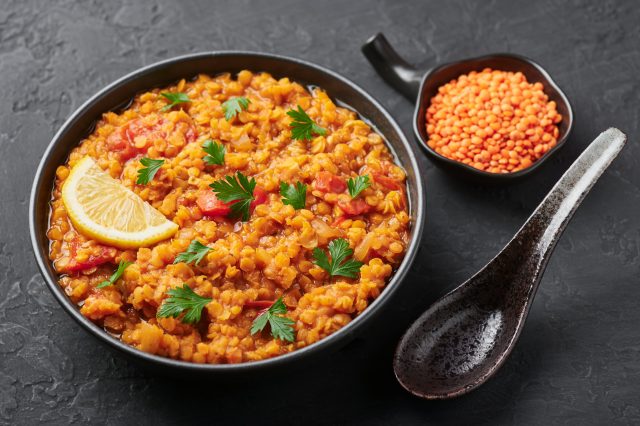 Red,Lentils,Dal,In,Black,Bowl,On,Dark,Slate,Table