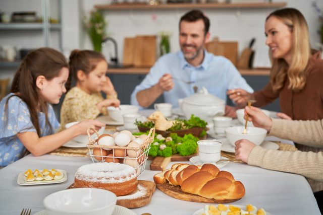 Caucasian,Family,Of,Five,Eating,An,Easter,Dinner,At,Home